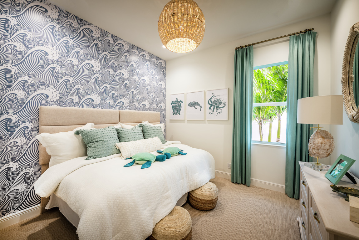Coastal-themed bedroom with wave-pattern wallpaper