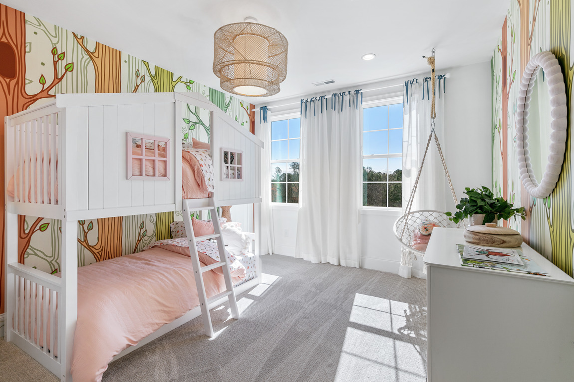 Kids’ bedroom with a jungle theme and whimsical tree wallpaper