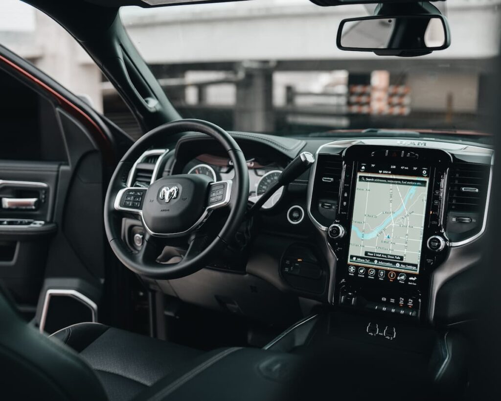 The interior of a connected car with a large navigation screen