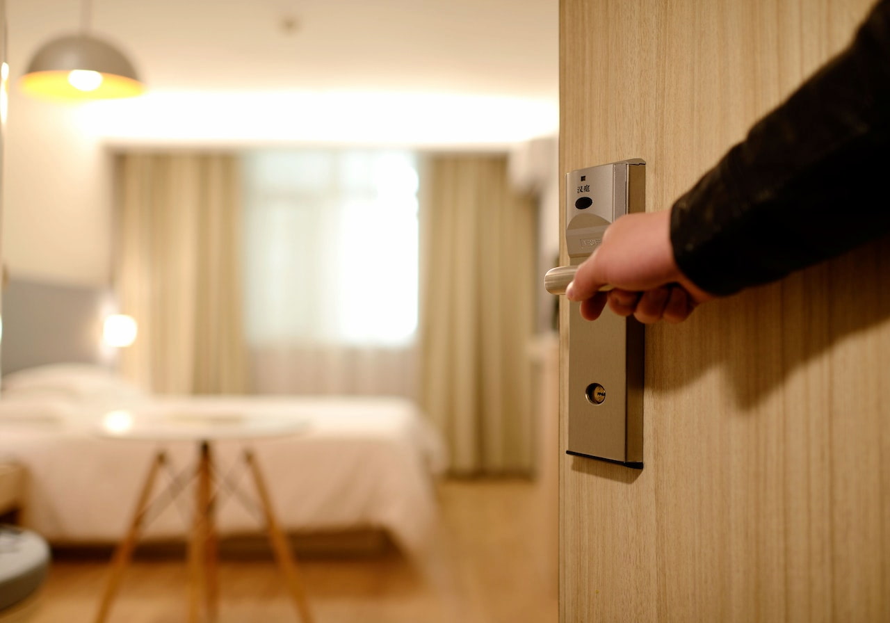 Someone closing a hotel room door