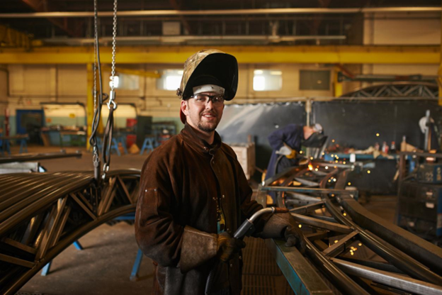 Choosing appropriate ATEX tools - A man working in a welding shop wearing protective equipment. Choosing appropriate ATEX tools - A man working in a welding shop wearing protective equipment.