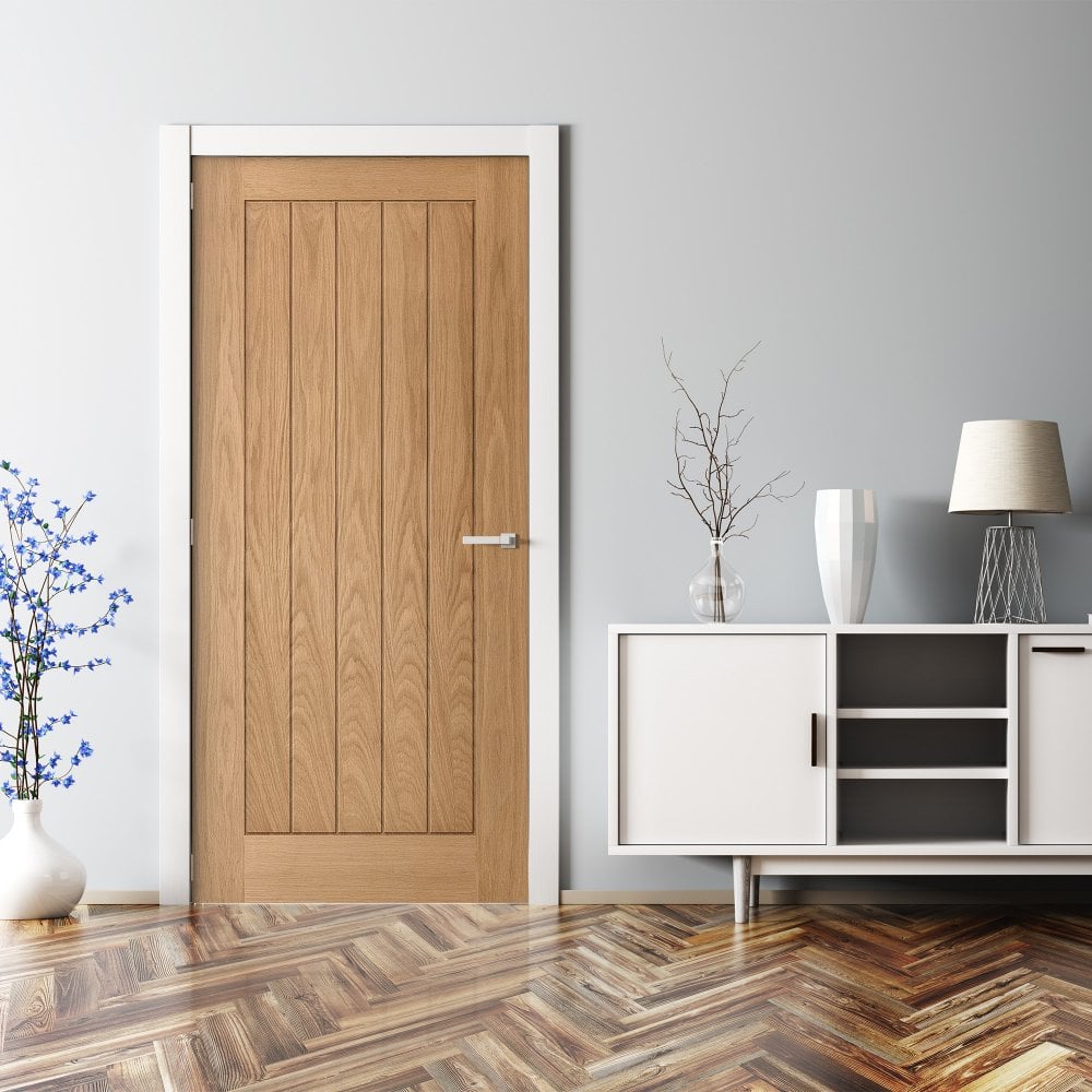 A brown wooden fire door with a silver handle in a white frame on a light grey wall.