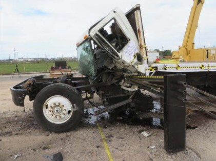 a side view of a truck being stopped by an anti-ram fence