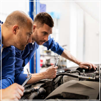 mechanics inspecting an engine