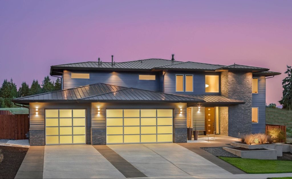 An architecturally modern home with lots of glass and symmetrical shapes.