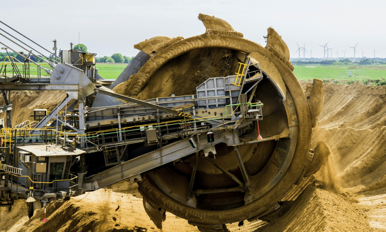 A mining operation in progress with a conveyor belt and other industrial equipment.