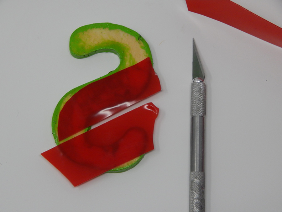 For the letters I used an ExactoÂ® blade to cut a more precise outline. The red silicone backing is a bit transparent, so you can easily see where you need to cut.