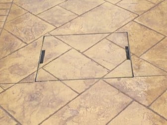 photograph of recessed manhole cover in a patio