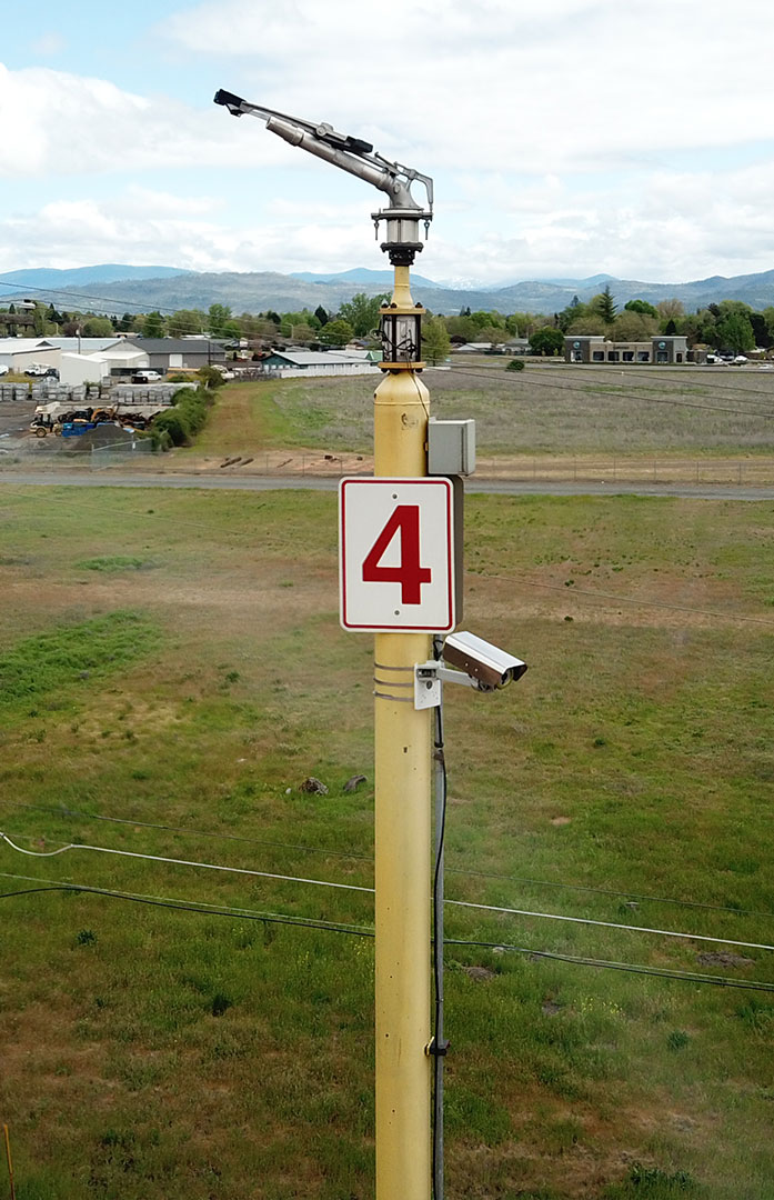 Early fire detection camera mounted on pole with water sprinkler, part of their strategic plan for power plant fire protection