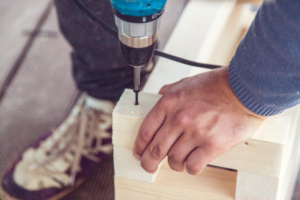 A carpenter drilling joint holes in wood
