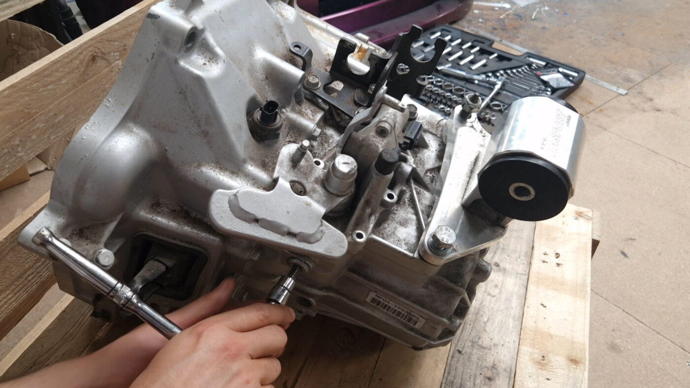 remove the bolt in the side of the housing