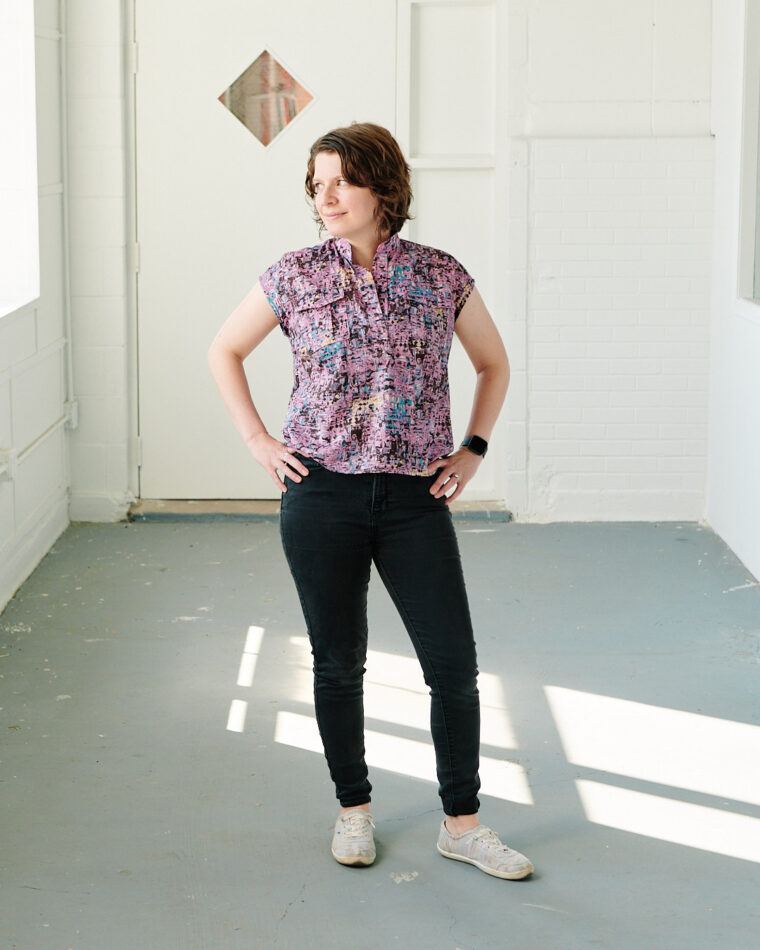 The final look of the Santa Rosa Top, featuring a woman standing in a hallway with sunlight streaming in through a window.