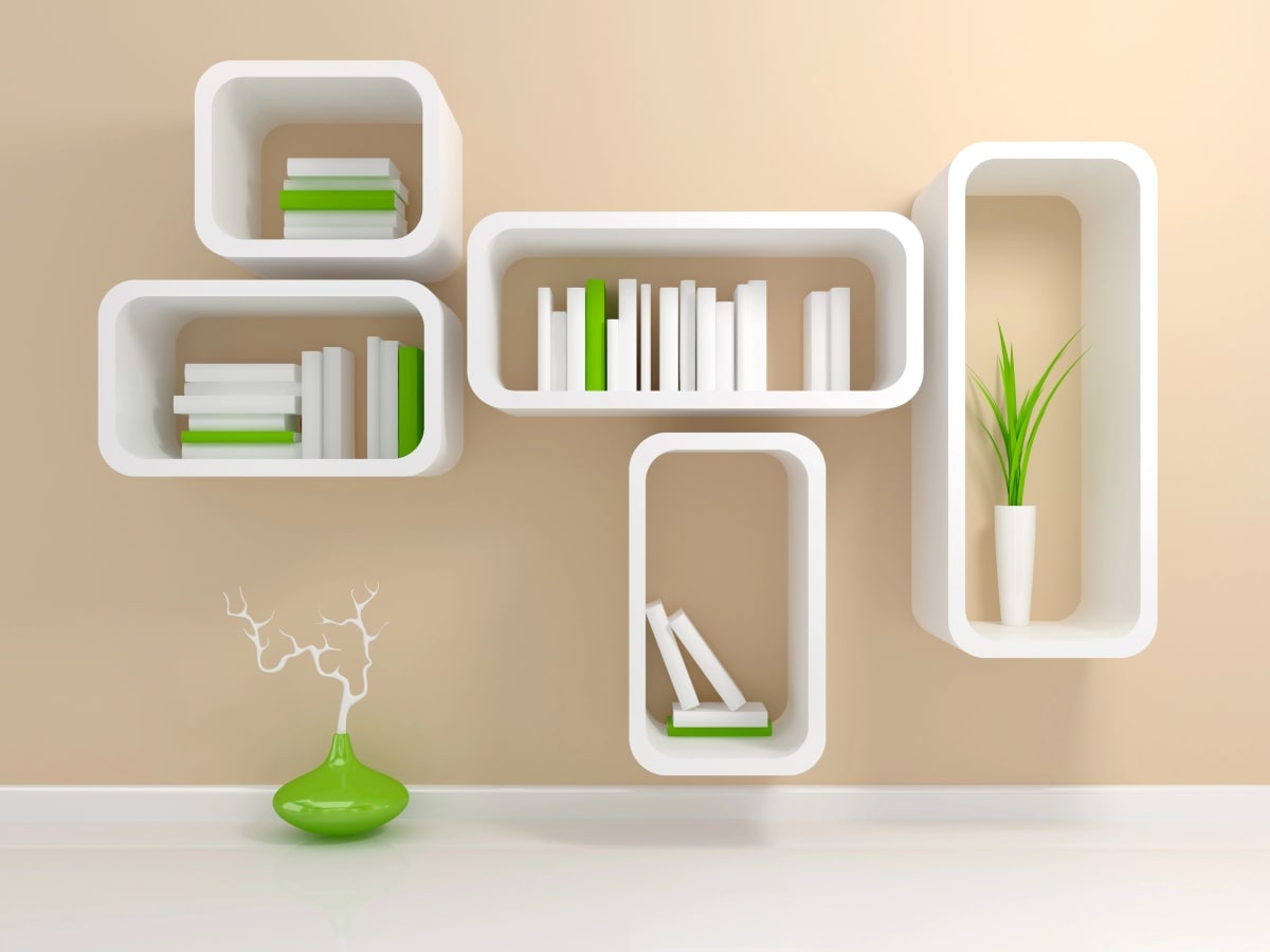 Minimalist floating shelves, featuring an arrangement of books and a decorative plant.