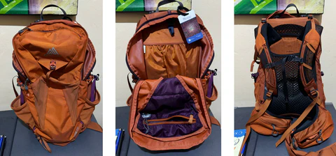 Rust red Gregory backpack from the front, with the main pocket open, and looking at the straps.