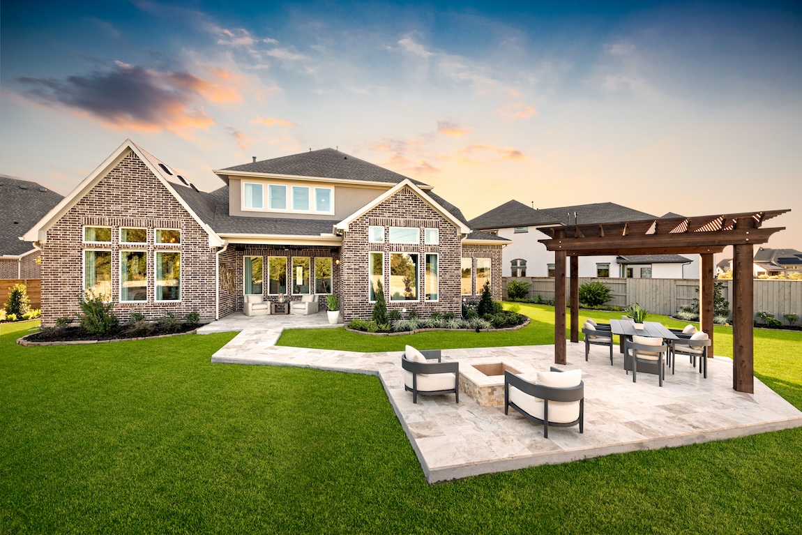 luxurious backyard with patio, fire pit, dining area, and pergola in Manvel, Texas