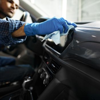 man cleaning car interior