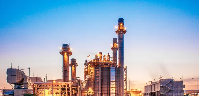 A sunset view of an industrial power plant.