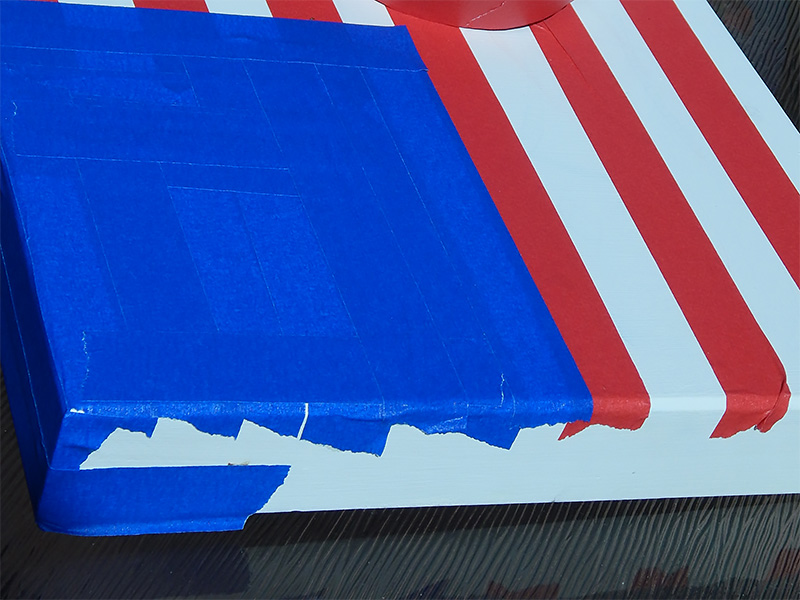 Use the ProÂ® 46 Colored Crepe Masking Tape in Blue to create the blue corner of your flag.