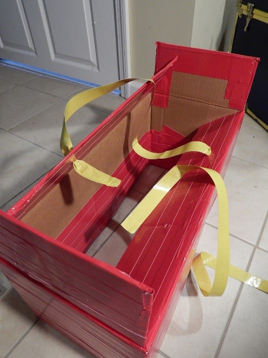 To get started I cut out the bottom of a diaper box and began to wrap it lengthwise in red ProÂ® Duct 120 tape from top-to-bottom and inside-and-out.