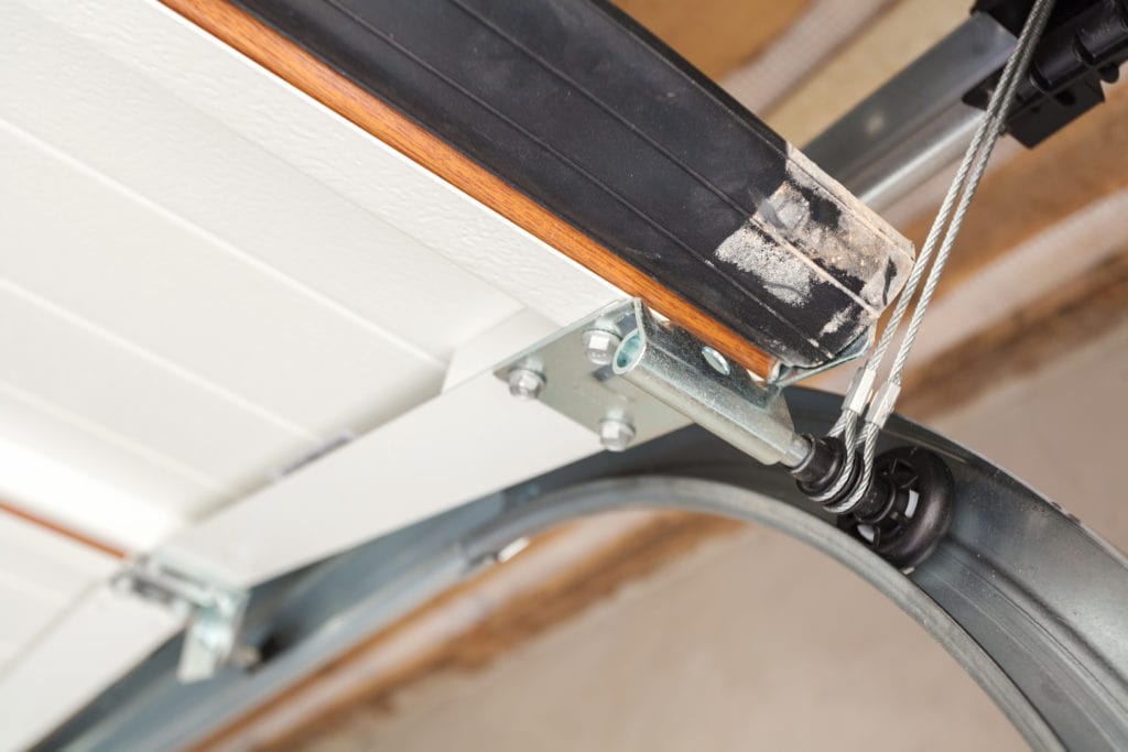 Close-up view of a garage door track while opening.