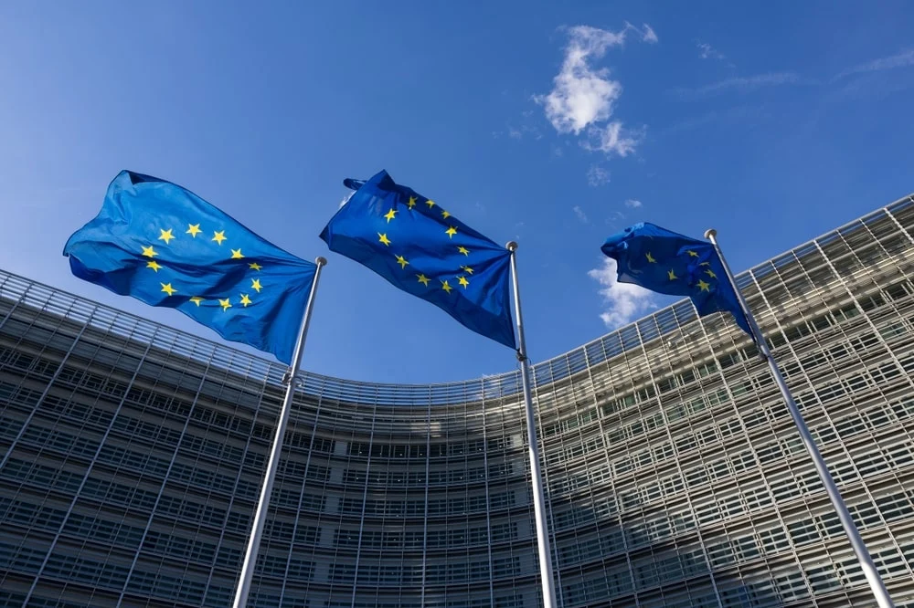 Three EU flags in front of a building