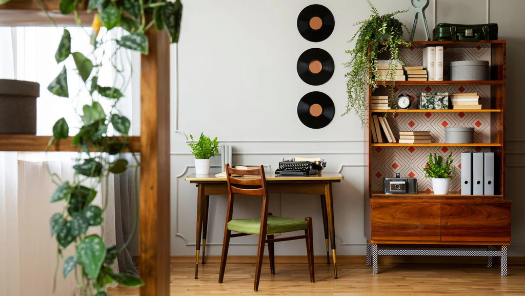 A home library adorned with greenery and an autumn palette