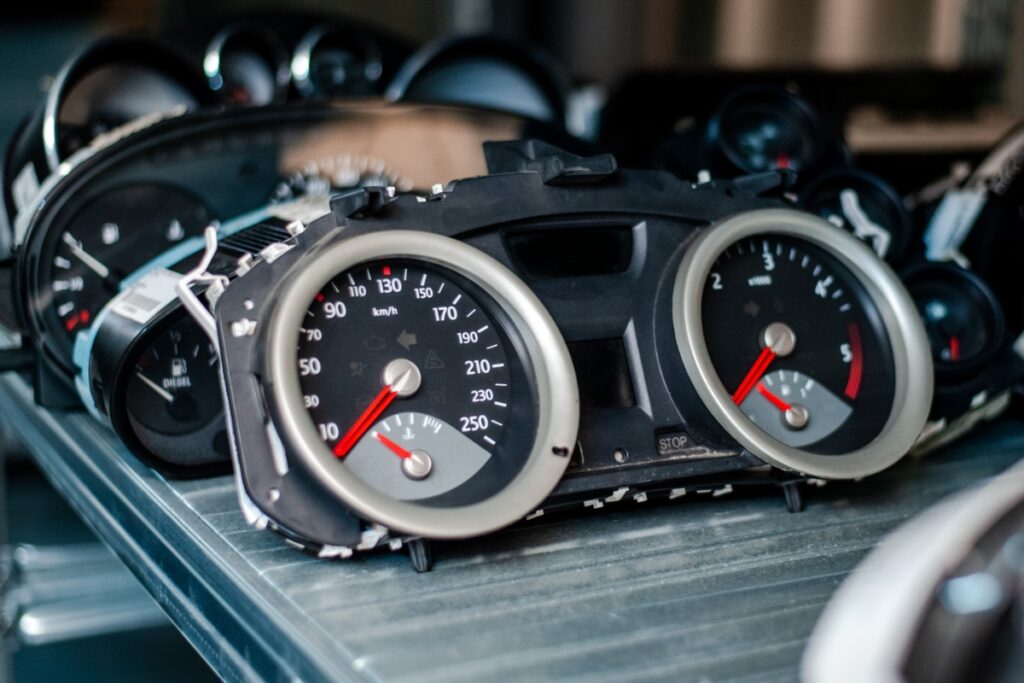 An instrument cluster on a metal shelf.