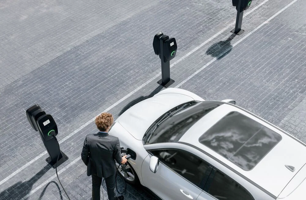 man using EVBox Liviqo AC business charger to charge his EV at the office.