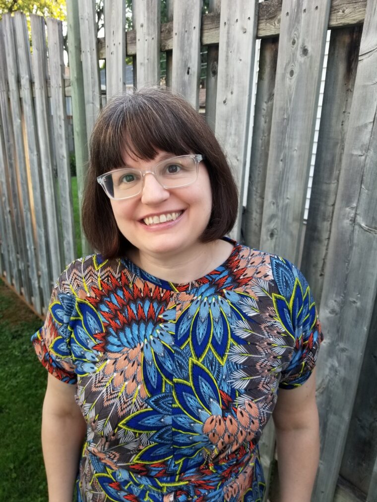 Close up of woman standing in back yard wearing handmade dress