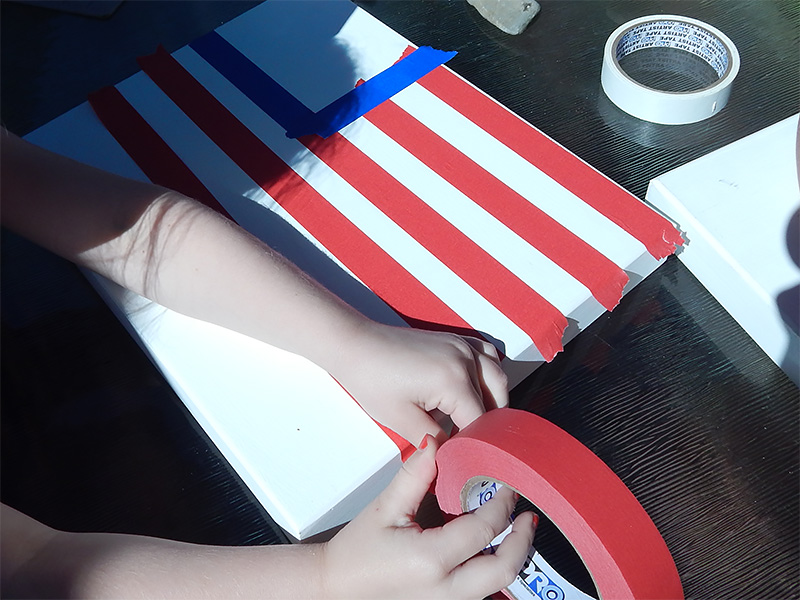 Start by placing the red stripes using ProÂ® 46 Colored Crepe Masking Tape in Red.