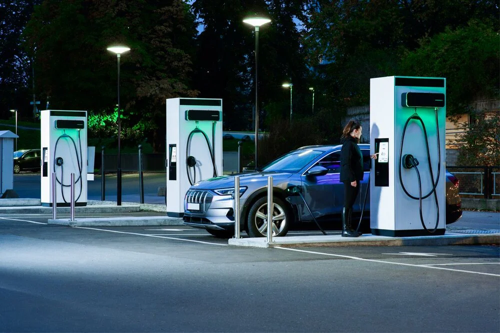 Three EVBox Troniq Modulars charging an electric car.
