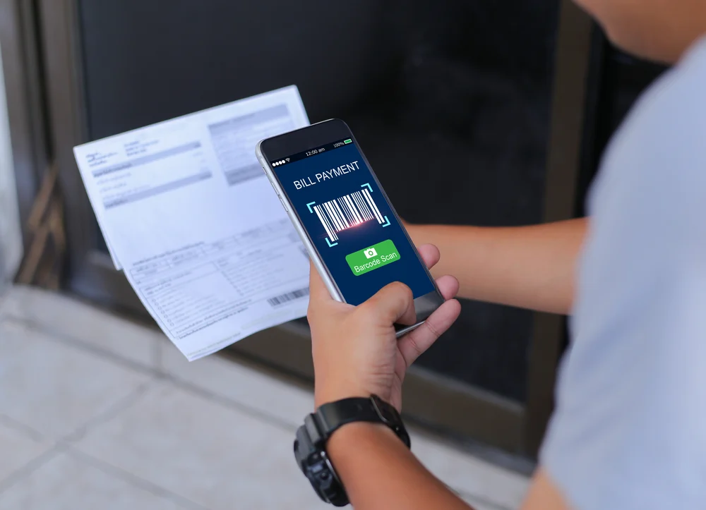A person paying an electricity bill on a smartphone.