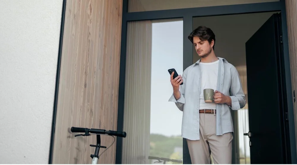 A man is checking his smart charging system with his phone.