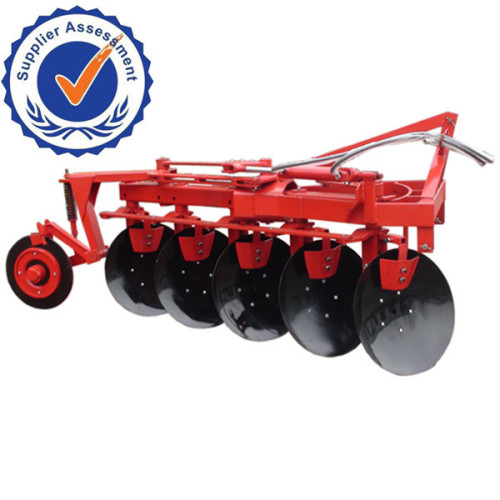 Farm Tractor driving reversible agricultural disc plough and disc plow