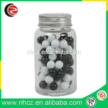 black and white round drawing pin in jar