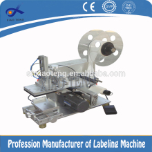 Semi-automatic small cap labeling machine
