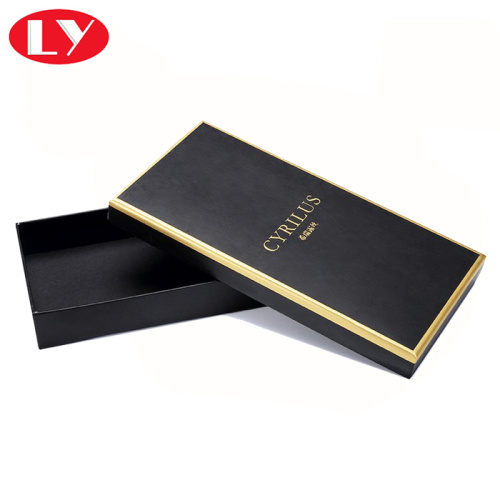 Black chocolate box packaging with gold foil logo
