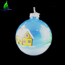 glass Christmas ball ornament with house patterns