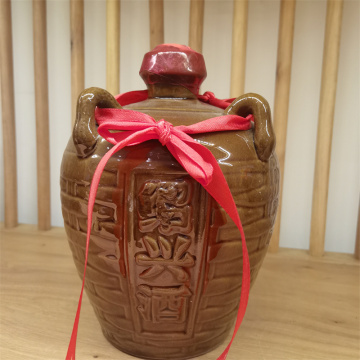Yellow porcelain jar filled with yellow wine
