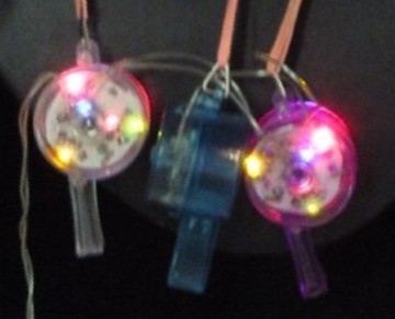 Plastic flashing whistle