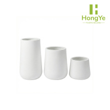 Three round and plump flowerpots of different sizes