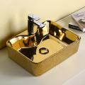 Lavabo redondo de baño mayorista de cerámica de lujo de color dorado y negro con lavabo de encimera nuevo diseño de lavabo de arte