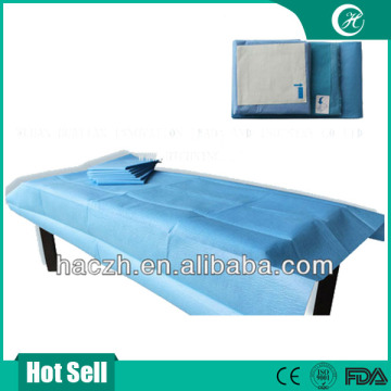 blue medical examination table disposable bed sheet
