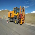 Highway guardrail piling machine