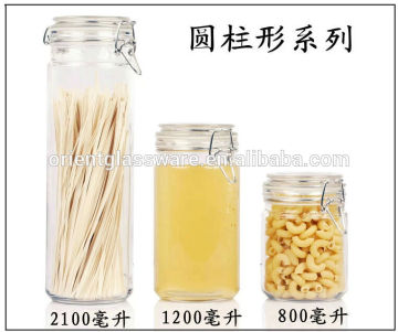 cylindrical clear glass jar with glass cap