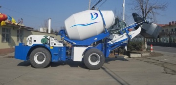 Mobile concrete mixer truck with self-loading