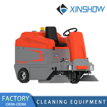 Driving a sweeping machine and road sweeper