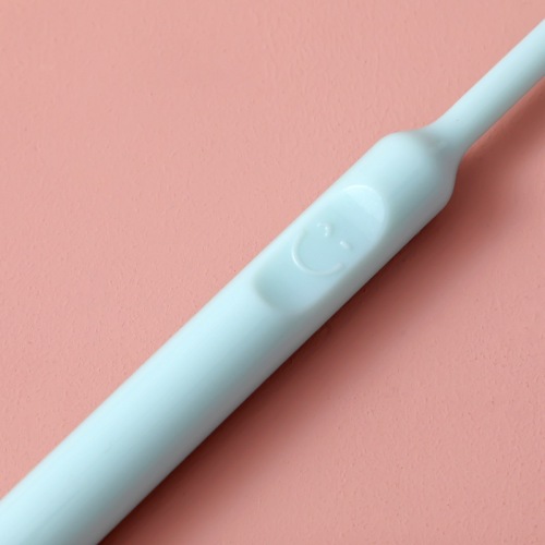 Candy colored smiley face toothbrush