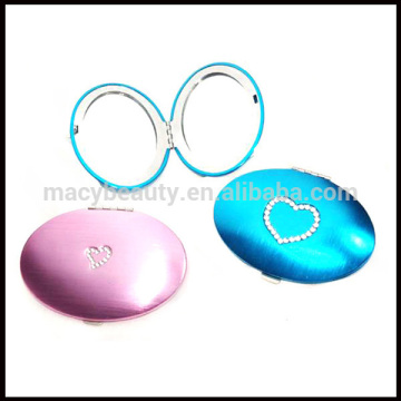 Oval metal makeup mirror with crystal