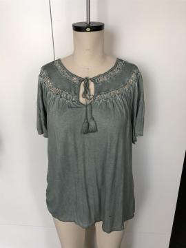 A short-sleeved blouse with tassel cut out